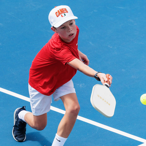Young pickleball player hitting a forehand shot on the courts at The Fort in Fort Lauderdale.