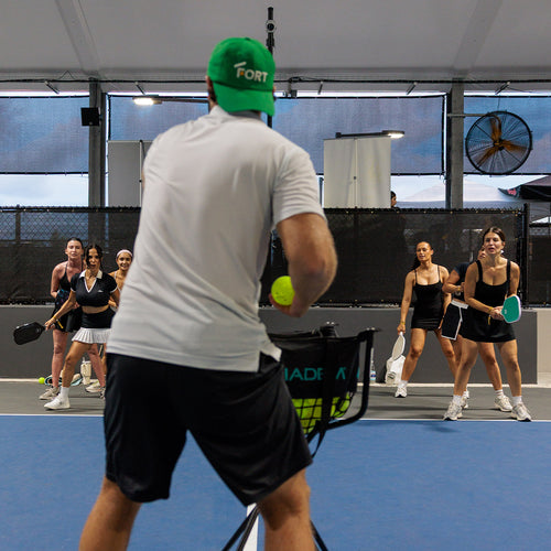 Pickleball players participating in a group training clinic at The Fort indoor courts in Fort Lauderdale.