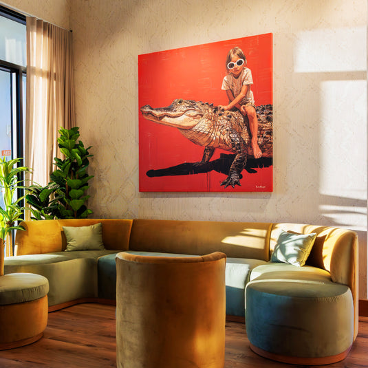 Modern lounge seating area at Serves and Thirds featuring alligator artwork and warm natural lighting